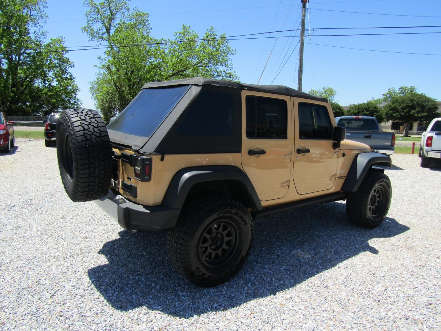 2013 Tan /Black Jeep Wrangler Unlimited Sahara 4WD (1C4HJWEG7DL) with an 3.6L V6 DOHC 24V FFV engine, Automatic transmission, located at 15016 S Hwy 231, Midland City, AL, 36350, (334) 983-3001, 31.306210, -85.495277 - Photo#7